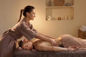 Relaxing spa massage with therapist and flower decor in a calming wellness environment.